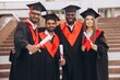 © anatoliycherkas - Group of Happy Graduates in Cap and Gown Holding Diplomas on Graduation Day