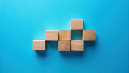 Aufkleber - Unassembled wooden blocks arranged in a unique pattern on a vibrant blue background, showcasing potential for creative construction and strategic thinking