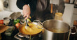 © peopleimages.com - Hands, cooking and chef with pot, culinary and preparation for dinner in kitchen, cuisine or restaurant. Catering, employee and person with food for supper, hospitality or skills for gourmet in diner