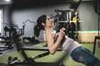 © FotoAndalucia - Woman in gym ding fitness exercises with suspension exercises