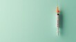 © muhammad - Medical syringe on mint green background