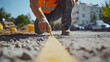 © Velem - Construction Worker Marking Ground with Yellow Paint