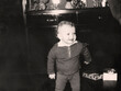 © Nataliia - Vintage portrait of a curly little boy. The child is learning to walk. Retro photo from 1967