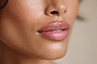 © Tondo - Close-up of glossy lips on smooth skin with neutral background