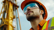 © Jorda - Construction Worker in Safety Gear Looking Up
