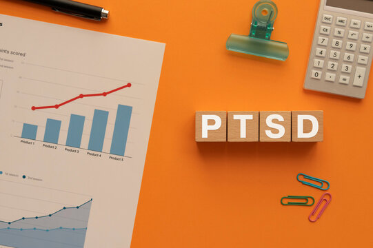 There is wood cube with the word PTSD. It is an abbreviation for Post-Traumatic Stress Disorder as eye-catching image.