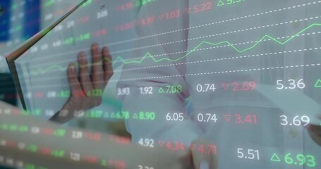 Poster - woman tapping tablet on finance desk, displaying overlaid stock market data graphics