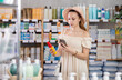 © JackF - Young woman buyer scanning qr code for sunscreen or tanning product in pharmacy