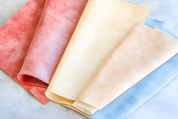 Poster - Close up of assorted colored leather swatches arranged on a light gray surface offering tactile texture and depth