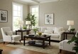 © Laki - Living room interior with white sofa, chairs, and dark wood coffee table