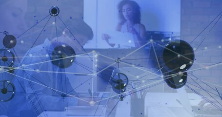 Poster - Man writing and woman pointing at monitor in business office, displaying network overlay graphic