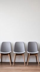 Poster - Minimalist Interior Design Featuring Three Gray Chairs Against a White Wall in a Modern Waiting Room or Office Space