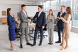 © Pixel-Shot - Business people shaking hands in conference room