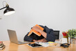 © jittawit.21 - Working late in the office. Stressed young man sitting at a table among books. Overworked guy sleeping