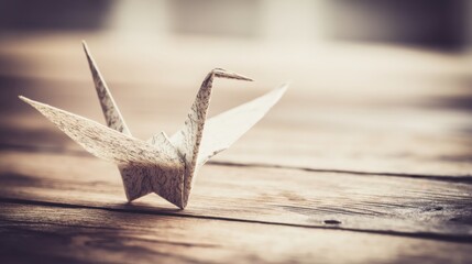 Poster - Elegant paper crane sculpture resting on a rustic wooden table symbolizing creativity and precision in business strategy