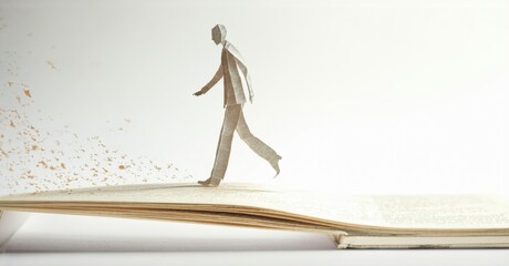 Aufkleber - Paper man walks upon open book. Concept suggests stories, imagination, journeys, possibilities. Bright light enhances surreal feel.