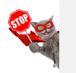 Aufkleber - Happy Cat wearing like a doctor with superhero cape and with stethoscope on his neck looks from behind white banner and shows stop sign. Isolated on white background