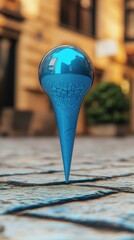 Poster - Blue Glass Sculpture Reflecting Urban Scene on Cobblestone Street Level View Artistic Composition