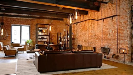 Aufkleber - This stylish living room features exposed brick walls, warm lighting, and a mix of contemporary furniture. A cozy arrangement invites relaxation, while shelves and plants enhance the aesthetic.
