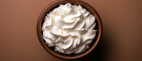 Poster - Overhead Studio Shot of Whipped Cream in Wood Bowl on Brown Background; Dessert Topping in Rustic Container for Food Photography