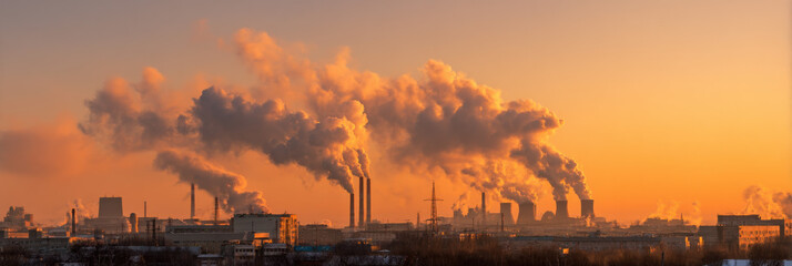 Poster - Industrial cityscape at sunset with large plumes of smoke rising from factory chimneys, casting an orange glow across the sky. : Generative AI