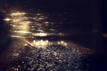 Wall Mural - abstract glitter black and gold lights background. de-focused