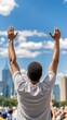 © Wanida - Person Celebrating Outdoors with Hands Raised Against City Background