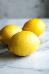 Poster - Three Fresh Lemons Arranged on White Marble Surface in Studio Still Life Close Up Food Photography