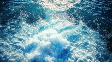 Poster - Ocean water churning with wave action and sunlight creating foam and texture aerial view nature background