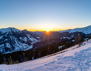 Wall Mural - breathtaking snowy mountain valley sunset, showcasing vibrant colors as sun dips below peaks. serene