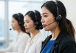 © Vooglo.com - Asian women wearing headsets working in a call center environment providing customer support