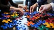 © salahudin - Diverse hands solving a puzzle