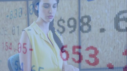 Poster - woman analyzing financial data at modern office desk, with floating blue and red numeric overlays