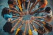 © photopixelstudio - Diverse group of people join hands in a circle outdoors.  Hands are placed together in a circular pattern.  Many different colored clothes and skin tones are seen
