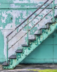 Poster - Weathered teal staircase against peeling wall close up industrial aesthetic urban decay texture detail