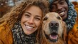 © gleb - Happy mixed-race couple and golden retriever posing together in winter clothes during snowfall perfect for holiday greeting visuals, friendship and pet lifestyle promotions
