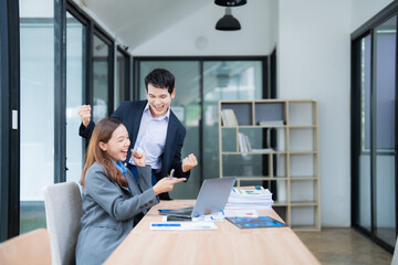 Poster - Asian businesspeople celebrating success, looking at laptop in meeting room, happy excited expression, achievement concept, business project complete