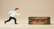 © Pixel Studio - A stylized businessman runs towards a wooden block displaying the word Opportunity symbolizing ambition success career growth and achieving goals in business and life.