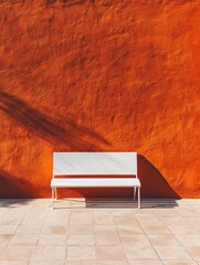 Aufkleber - White bench against orange wall in sunlight, minimalist composition, architectural detail, outdoor scene, summer day