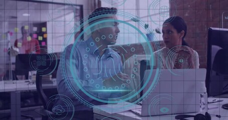 Poster - Two colleagues leaning over laptop discussing business in office showing circular security graphics