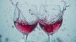 © elisa - Two wine glasses clinking together with splashes