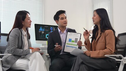 Poster - Asian businesspeople discussing marketing strategy during a meeting in a modern office, analyzing financial charts and graphs, collaborating on innovative solutions for business growth