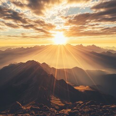 Wall Mural - Mountain range at sunrise with sunbeams shining through the clouds aerial view nature landscape