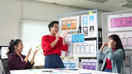 Fototapete - Creative team members expressing joy and excitement after completing user interface design, showcasing positive teamwork and achievement in modern workspace