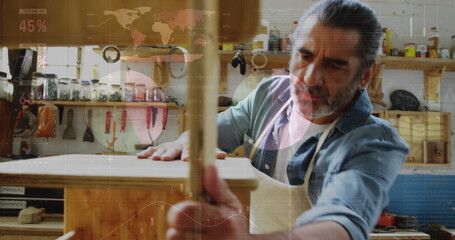 Poster - Image of world map and data processing over caucasian male carpenter working in workshop