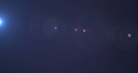 Poster - Digital image of spot of light moving against copy space on blue background