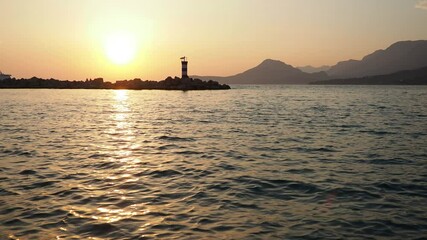 Poster - Experience the tranquil beauty of the Adriatic Sea as ships glide through shimmering waters. Witness the sun setting behind majestic mountain scenery, capturing a magical moment in time