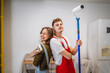 © Miljan Živković - Portrait of boyfriend and girlfriend stand with paint roller