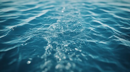 Poster - Tranquil blue water surface capturing sunlight reflections in serene waves.
