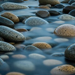 smooth river stones with soft flowing water close-up